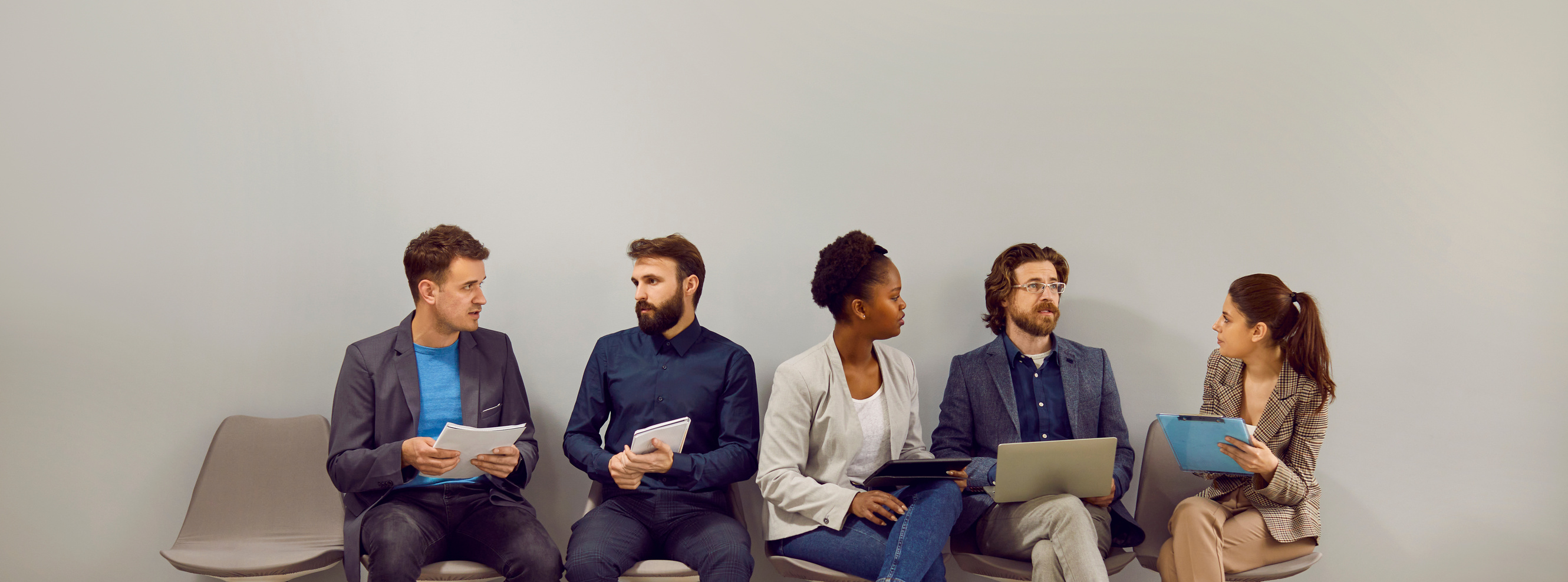 Multiracial People Men and Women Waiting in Line for Interview at Large Company Sits near Wall